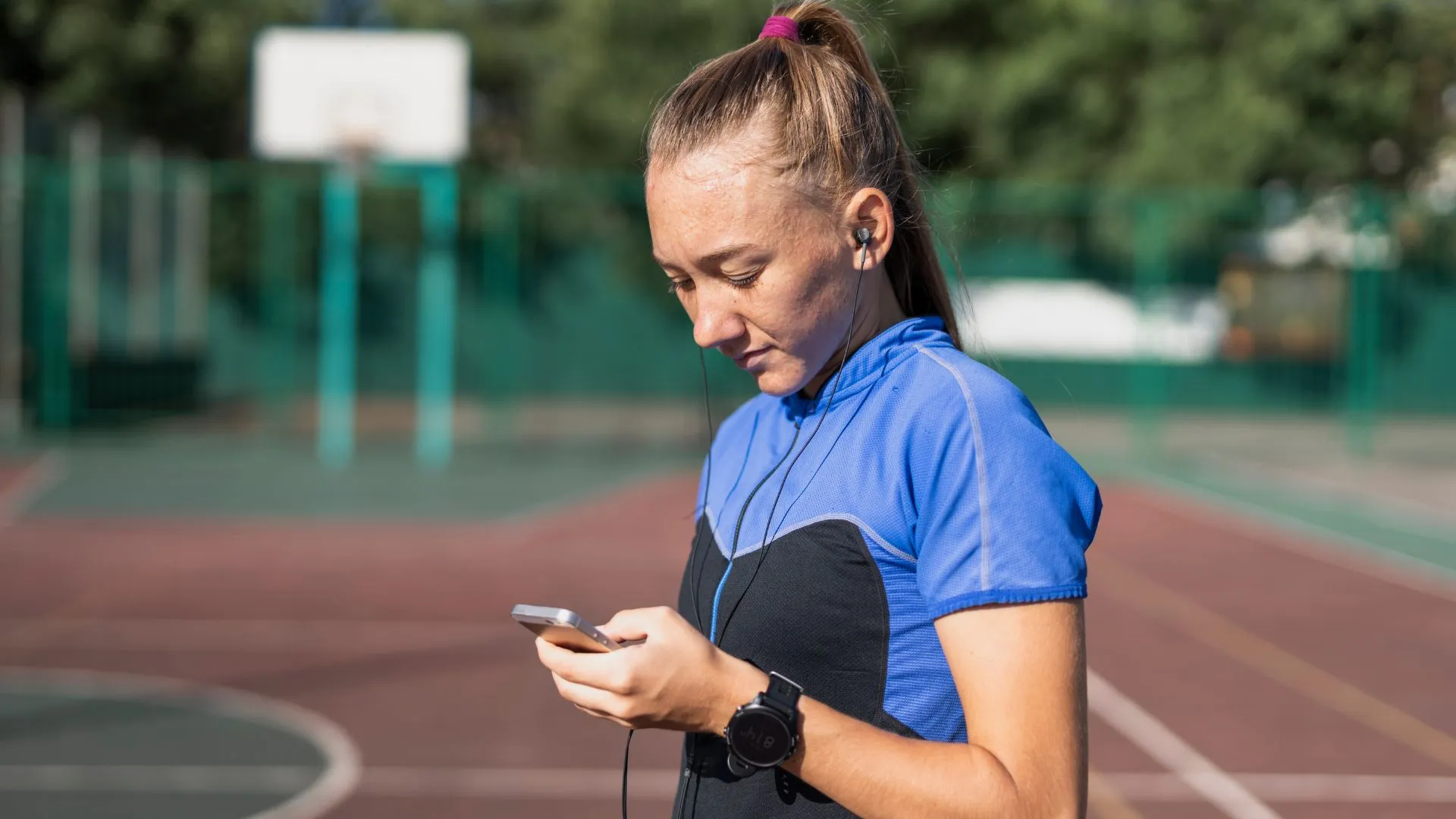 A runner reviews her average cadence stats on her smartphone after a training session.