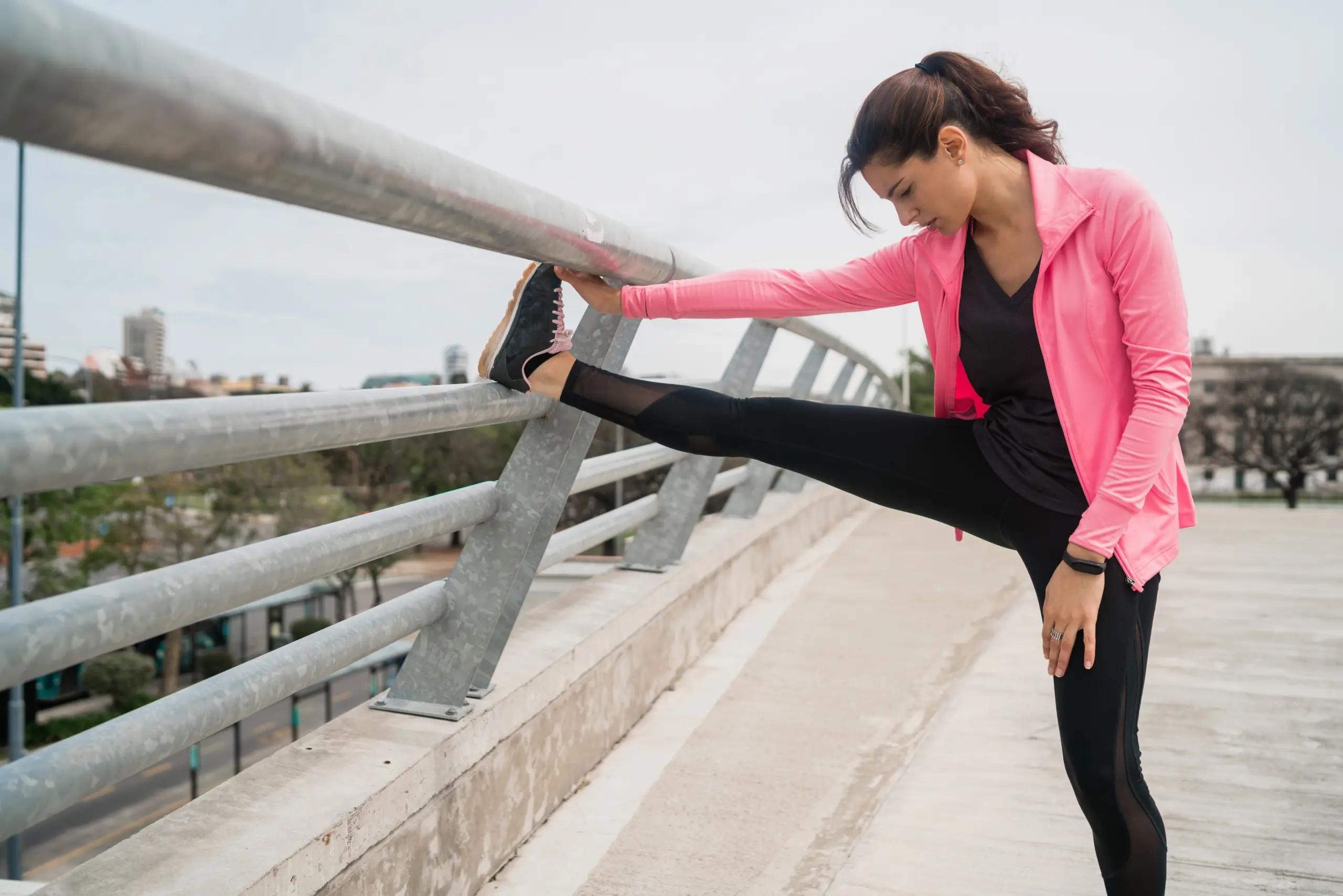 Women relieving muscle tension with leg stretches after a workout.
