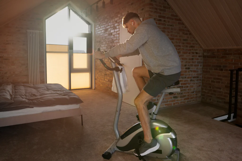 Using a stationary bike at home for active recovery and to relieve sore legs after running.