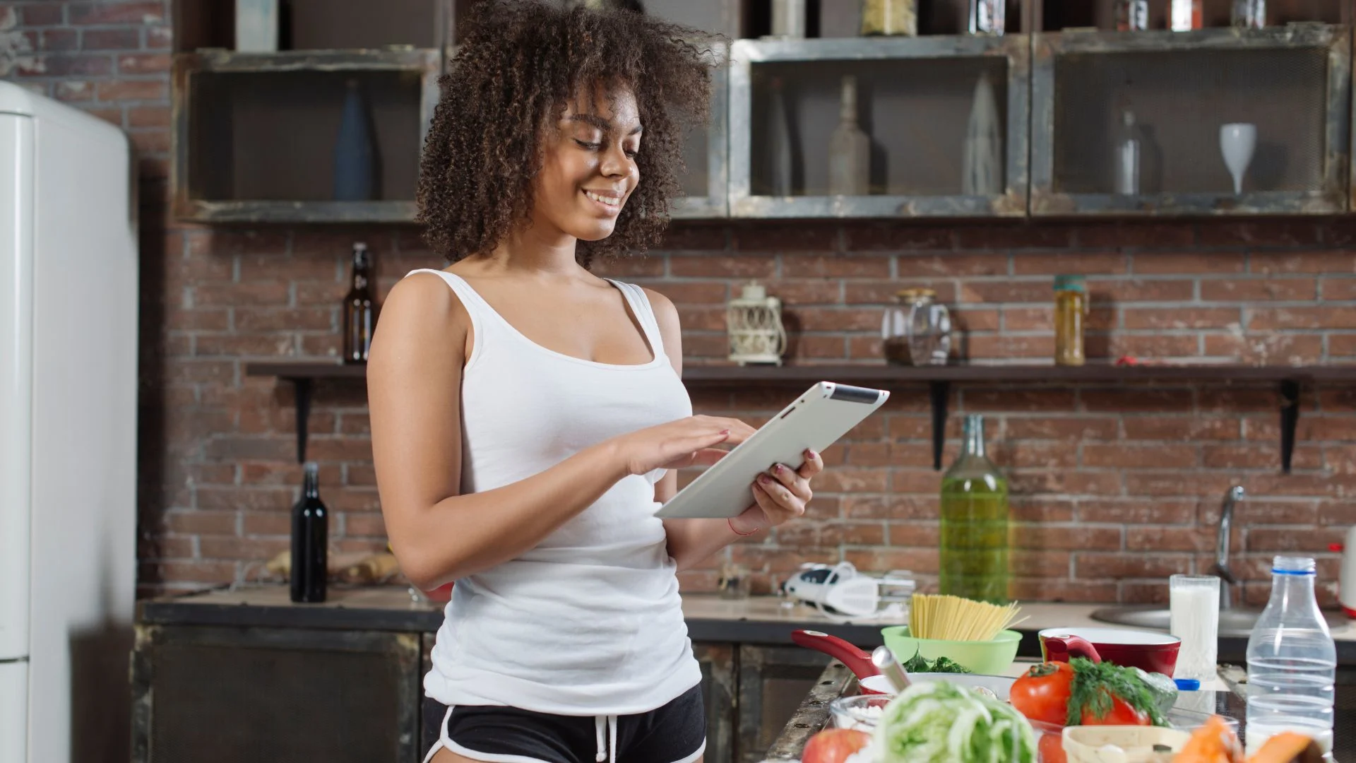 A runner preparing a meal with various healthy carbohydrates for runners.